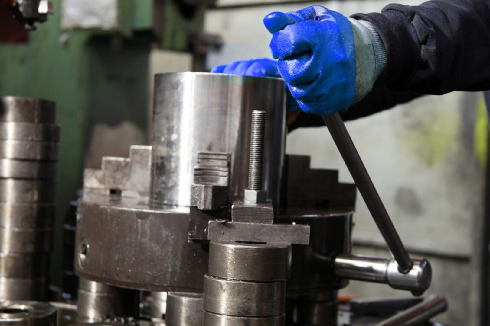 Technician inspecting a hydraulic fitting for leaks.